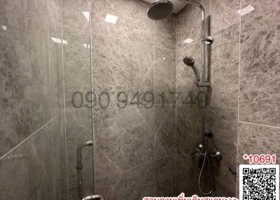 Modern bathroom interior with glass shower and grey tiles