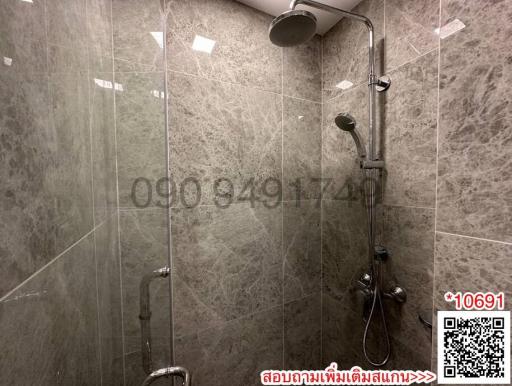 Modern bathroom interior with glass shower and grey tiles