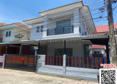 Modern two-story house with covered parking and a secure gate