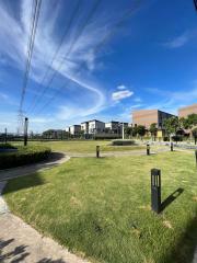 Modern residential neighborhood with lush greenery and clear blue sky