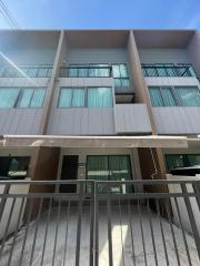 Modern two-story residential building facade with sun shades