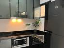 Modern kitchen with stainless steel appliances and black cabinetry