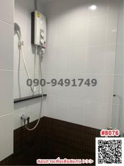 Modern bathroom with wall-mounted electric heater and handheld shower