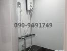 Modern bathroom interior with an electric shower and white tiles