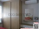 Cozy bedroom with large wardrobe and air conditioning