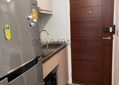 Modern compact kitchen with stainless steel appliances and wooden cabinetry