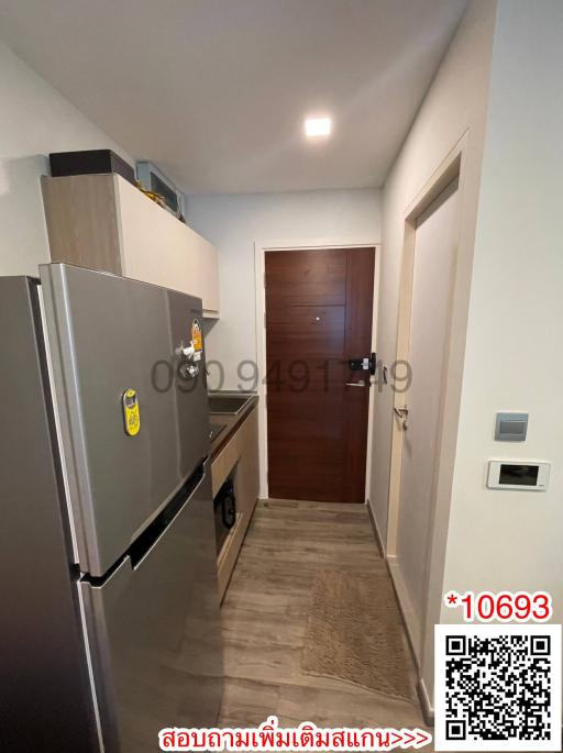 Cozy entrance hallway with modern appliances and wooden door