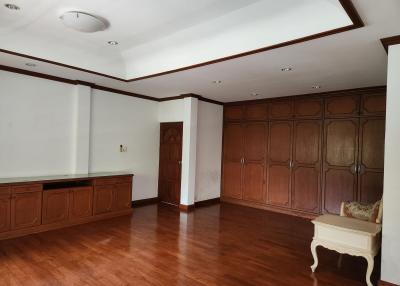 Spacious living room with hardwood flooring and elegant wood paneling