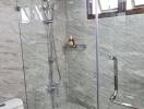 Modern bathroom with glass shower and marble tiles