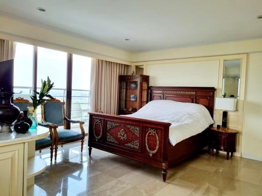 Elegant bedroom with a classic wooden bed and a scenic window view