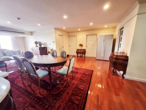 Spacious dining room with large table and hardwood floors