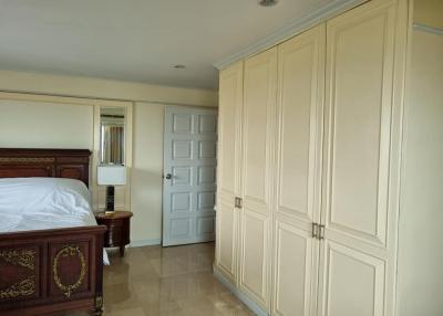 Elegant bedroom with large wooden bed and spacious wardrobe