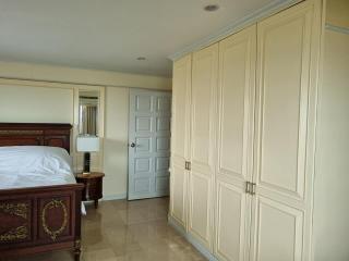 Elegant bedroom with large wooden bed and spacious wardrobe