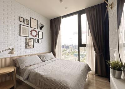 Cozy bedroom interior with city view through large window