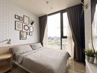Cozy bedroom interior with city view through large window