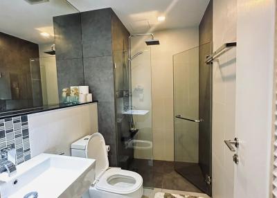 Modern bathroom interior with a shower, toilet, and sink