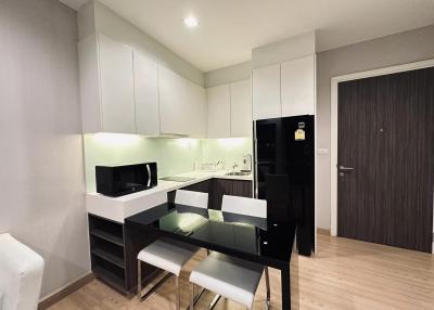 Modern kitchen with dining area, equipped with up-to-date appliances and ample cabinet space