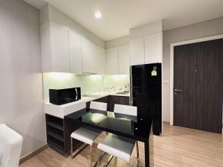 Modern kitchen with dining area, equipped with up-to-date appliances and ample cabinet space