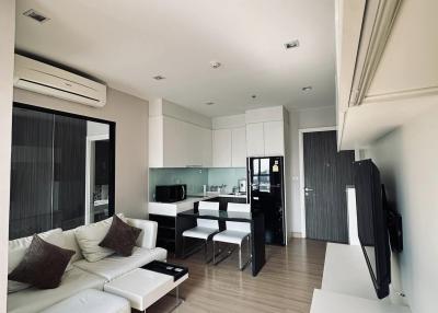 Modern open-concept living area with kitchenette