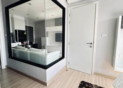 Modern bedroom with large mirror and air conditioning unit