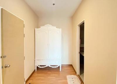 Spacious hallway with wooden flooring and a white wardrobe