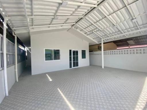 Spacious tiled garage with high ceiling and natural light