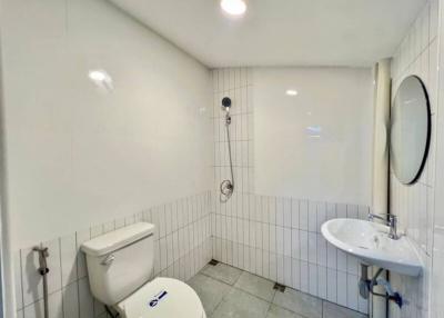 Compact bathroom with white tiling and modern fixtures