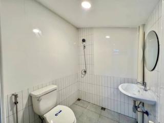 Compact bathroom with white tiling and modern fixtures