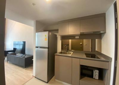 Modern kitchen with open floor plan to the living area in a contemporary apartment