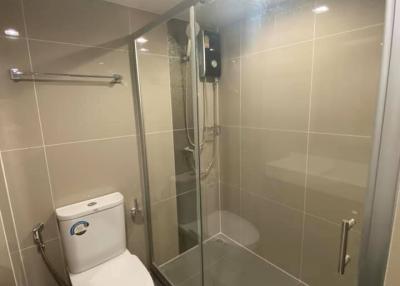 Modern bathroom with glass shower enclosure and wall-mounted toilet