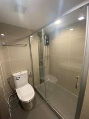 Modern bathroom with glass shower enclosure and wall-mounted toilet