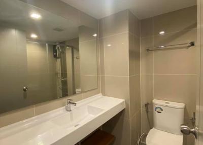 Contemporary bathroom interior with large mirror and modern fixtures