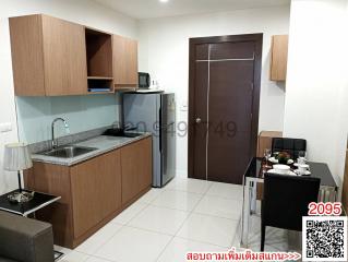 Compact modern kitchen with dining area and appliances