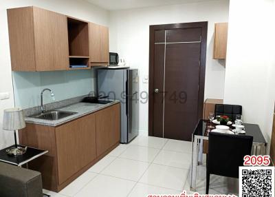 Compact modern kitchen with dining area and appliances