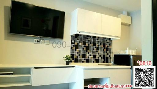 Modern kitchen with white cabinetry and black and white backsplash