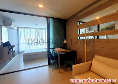 Modern bedroom with office space and balcony access in a residential apartment