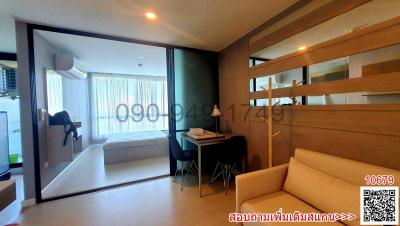 Modern bedroom with office space and balcony access in a residential apartment