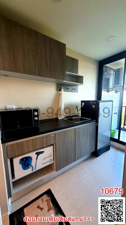 Modern compact kitchen with wooden finish and appliances