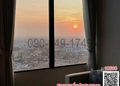 Bedroom with a view of the sunset through large windows