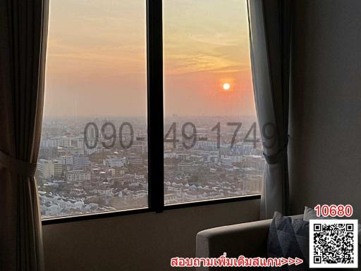 Bedroom with a view of the sunset through large windows