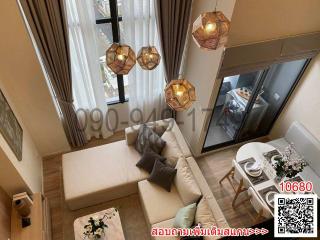 Modern living room with high ceiling and unique pendant lights