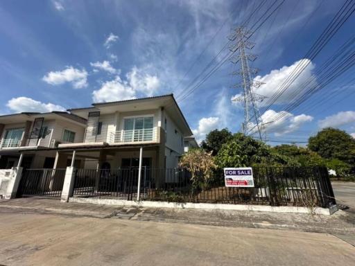 Spacious two-story house for sale with a clear blue sky in the background