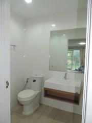 Modern bathroom with white fixtures and large mirror