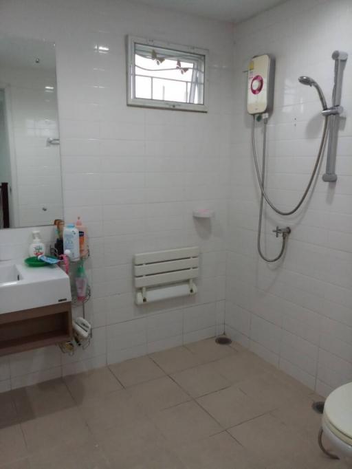 Clean and well-maintained bathroom with white tiles