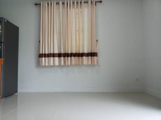 empty room with curtains and tiled floor