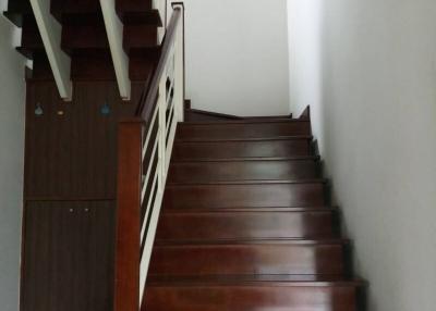 Wooden staircase with white walls in a modern house