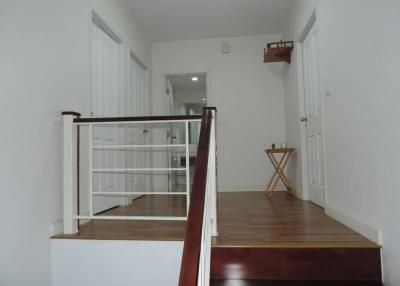 Bright staircase with wooden flooring leading to upper level of a home