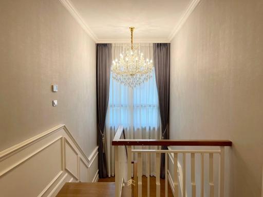 Elegant hallway interior with chandelier and wooden flooring