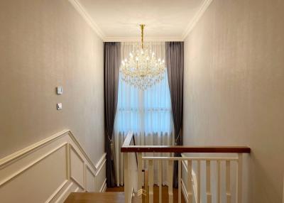 Elegant hallway interior with chandelier and wooden flooring