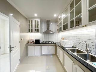 Modern kitchen with white cabinetry and stainless steel appliances